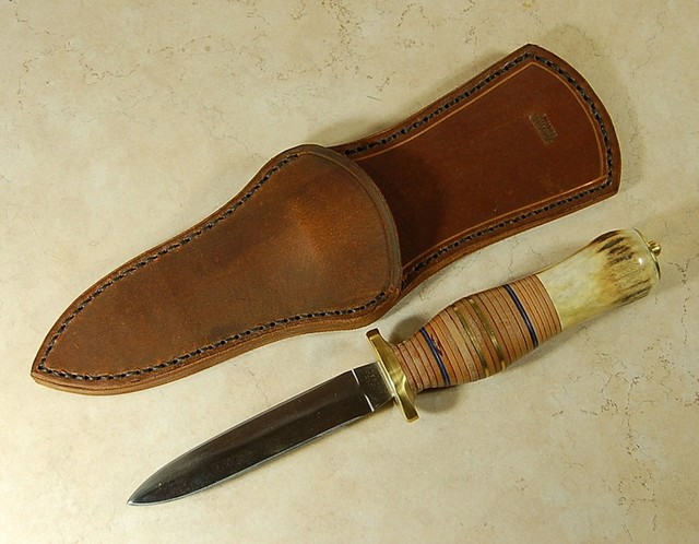 Another fine dagger by Roger, stacked leather and antler handle with a brass buttcap